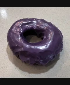 The Ube Dream cannabis-infused doughnut from Iron Leaf Cannabis Co., featuring a vibrant purple ube glaze and a soft, fluffy texture. Perfectly balanced flavors of earthy ube and the relaxing effects of cannabis make it an irresistible treat.